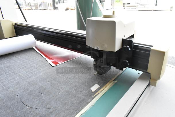 Mimaki CF-0912-2 flatbed cutter in good condition, featuring a sleek cutting head and visible control labels.