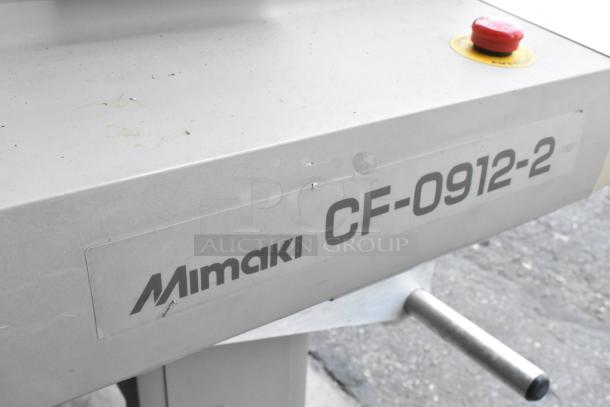 Mimaki CF-0912-2 Flatbed Cutter, metallic finish, visible label with model name, features control button, good condition.