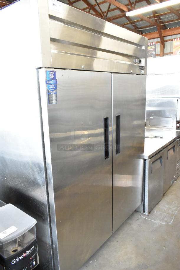Dukers D55AR stainless steel 2-door commercial cooler with poly-coated racks, on casters. 115V, 1 phase. Warranty tag visible.