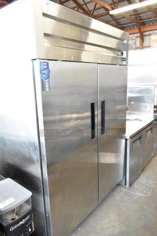 Dukers D55AR stainless steel 2-door commercial cooler with poly-coated racks, on casters. 115V, 1 phase. Warranty tag visible.