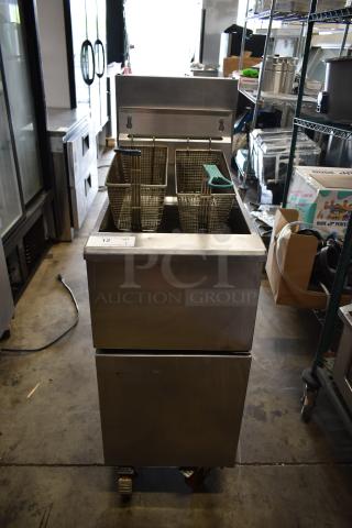 Stainless Steel Commercial Floor Style Gas Powered Deep Fat Fryer w/ 2 Metal Fry Baskets on Commercial Casters.