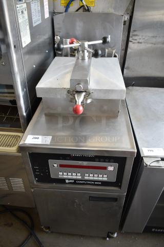 Henny Penny 600C Stainless Steel Commercial Floor Style Natural Gas Powered Pressure Fryer on Commercial Casters. 80,000 BTU.