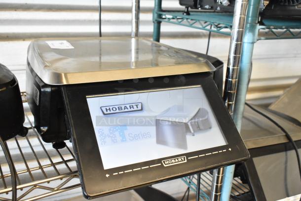 Hobart HT Series commercial scale with touchscreen display, stainless steel top; good condition, minor wear.
