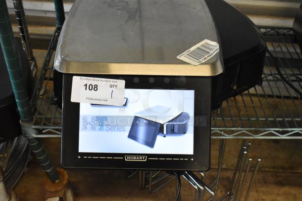 Hobart HT Series electronic scale with touchscreen display, stainless steel top, auction tag number 108, good condition.