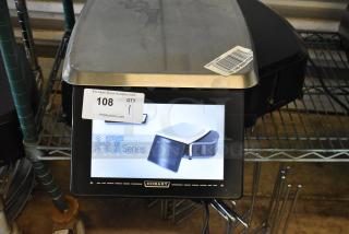 Hobart HT Series electronic scale with touchscreen display, stainless steel top, auction tag number 108, good condition.