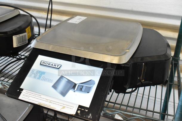 Hobart HT Series scale in good condition featuring a stainless steel platform and digital display with product label.