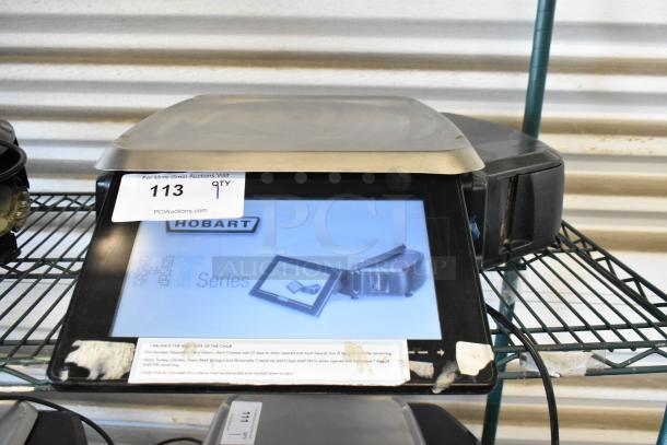 Hobart commercial scale, black, digital display, model HT Series, with tag "113" from PCI Auctions. Good condition.
