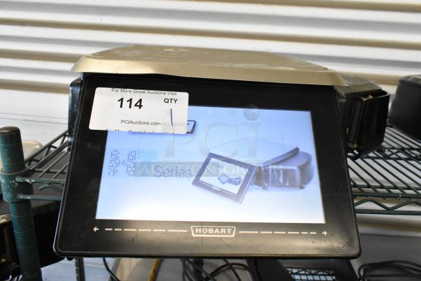 Hobart HT Series touch screen scale, condition appears used, auction tag 114 visible, indicating auction source.