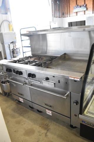 Vulcan 60SS-6B24GTN Stainless Steel Commercial Natural Gas Powered 6 Burner Range w/ Flat Top Griddle, 2 Ovens, Over Shelf and Back Splash on Commercial Casters.