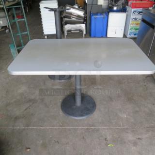 One Gray Laminate Table Top On A Pedestal Base. 48X30X30
