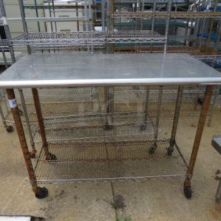 One Stainless Steel table With A Metro Under Shelf On Casters. 49.5X24X39