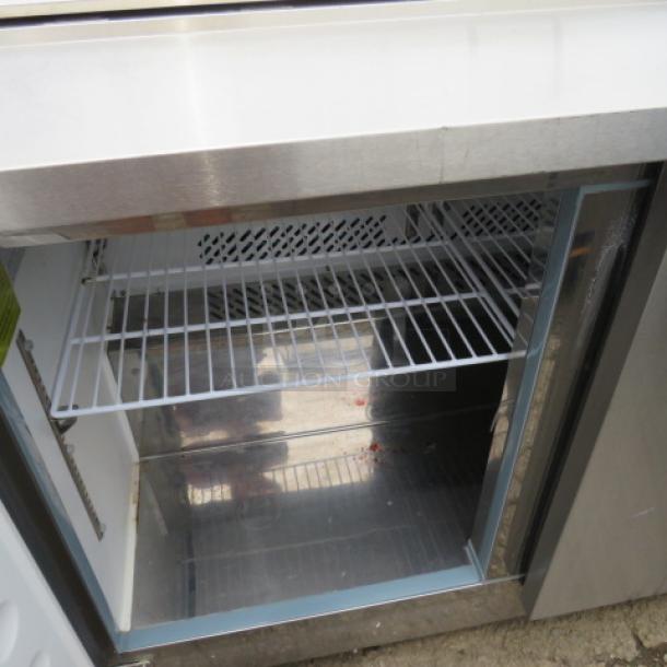 One Artic Air 2 Door Refrigerated Prep Table With 2 Racks On Casters.  Model# AST48RZ. 115 Volt. Working NOT COLD. 49X30X44 - Image 2 of 3