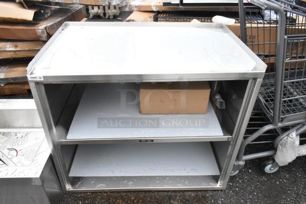 BRAND NEW SCRATCH AND DENT! Regency 600CT3S2133E 21" x 33" Three Shelf 18-Gauge 304 Stainless Steel Utility Cart with Enclosed Base and Open Front - Image 1 of 5