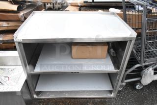BRAND NEW SCRATCH AND DENT! Regency 600CT3S2133E 21" x 33" Three Shelf 18-Gauge 304 Stainless Steel Utility Cart with Enclosed Base and Open Front