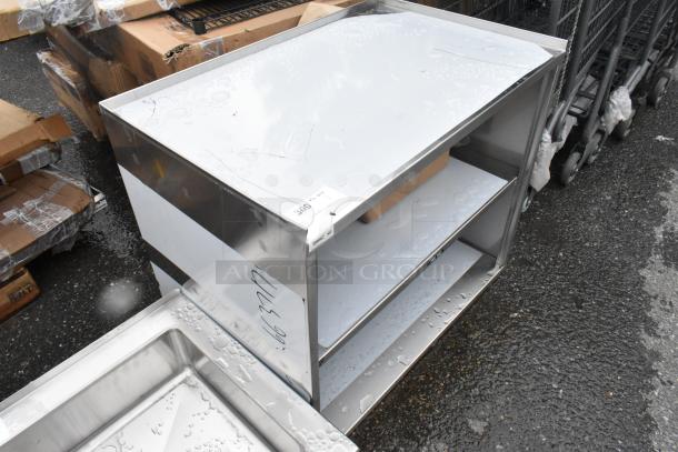 BRAND NEW SCRATCH AND DENT! Regency 600CT3S2133E 21" x 33" Three Shelf 18-Gauge 304 Stainless Steel Utility Cart with Enclosed Base and Open Front - Image 2 of 5