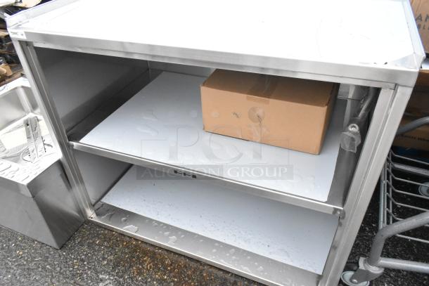 BRAND NEW SCRATCH AND DENT! Regency 600CT3S2133E 21" x 33" Three Shelf 18-Gauge 304 Stainless Steel Utility Cart with Enclosed Base and Open Front - Image 4 of 5