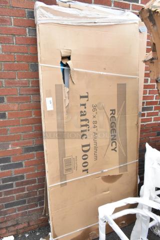 2 BRAND NEW SCRATCH AND DENT! Regency 600TD3684 Single Aluminum Swinging Traffic Door with 9" x 14" Window - 36" x 84" Door Opening. 2 Times Your Bid!
