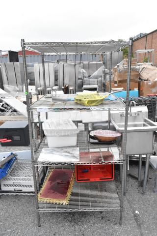 Chrome Finish 4 Tier Wire Shelving Unit w/ Contents Including Skillet. BUYER MUST DISMANTLE. PCI CANNOT DISMANTLE FOR SHIPPING. PLEASE CONSIDER FREIGHT CHARGES.