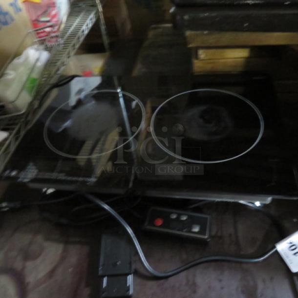 Electric double burner cooktop with black glass surface, attached control panel, and visible power cord, fair condition.