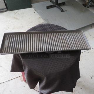 Metal grilling tray with ribbed surface, in good condition, rectangular shape, approximately 24 inches long.