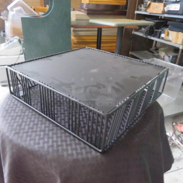 Black metal wire basket with flat top, square shape, and decorative twisted edges. Good condition, no visible markings.
