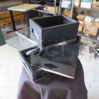 Three black wooden storage boxes with cut-out handles, displayed on a table. In good condition, no visible markings.