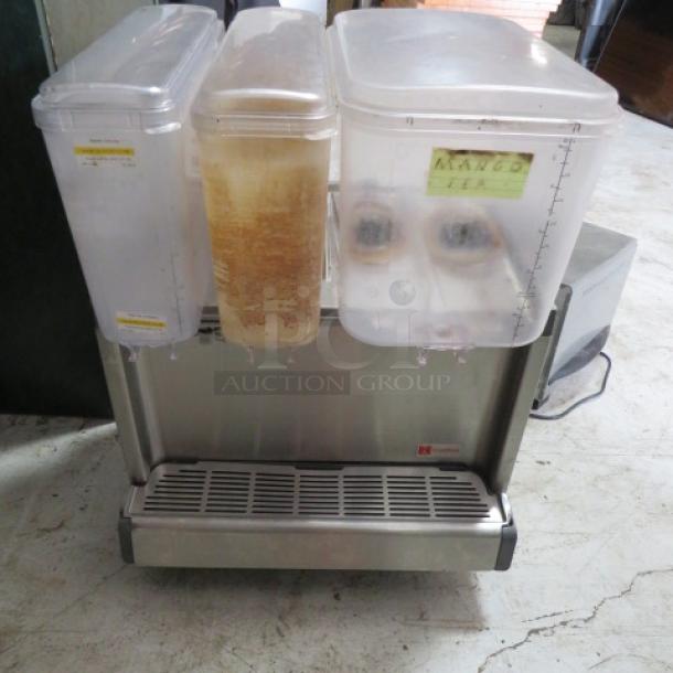 Commercial beverage dispenser with three clear containers, stainless steel base, labeled for iced tea, used condition.
