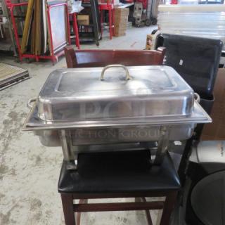 Stainless steel chafing dish with lid and handles, used condition, suitable for catering or events.