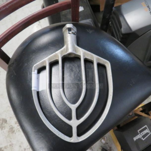Metal dough mixer paddle attachment, silver, used, slight wear. Suitable for commercial mixers, durable construction.