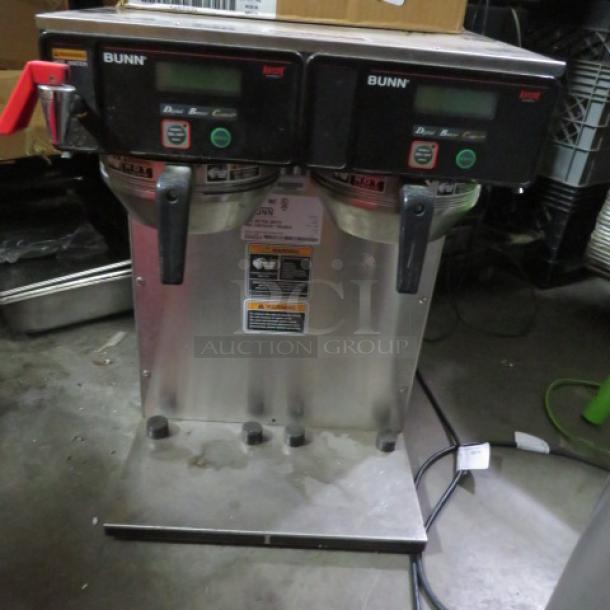 Bunn dual coffee brewer, stainless steel, two burners, digital controls, model visible. Used condition, cords attached.