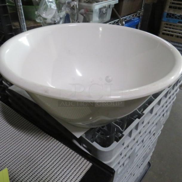 White ceramic washbasin, large round shape, smooth finish, minor scuffs, in good condition, no visible markings.