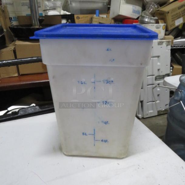 Clear plastic storage container with blue lid, capacity markings from 4 to 18 quarts, used condition, minor discoloration.