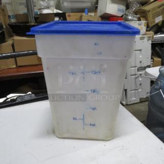 Clear plastic storage container with blue lid, capacity markings from 4 to 18 quarts, used condition, minor discoloration.