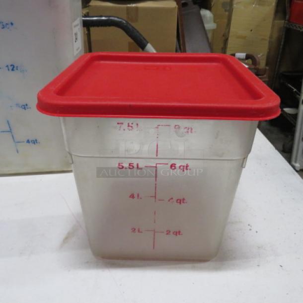 Clear plastic storage container with red lid, marked with measurements up to 6 quarts/5.5 liters. Used condition.