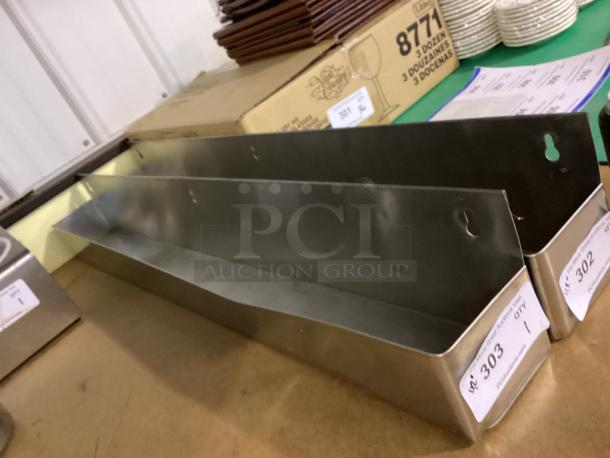 Pair of stainless steel wall-mounted bottle holders with mounting holes, labeled with auction tags 302 and 303, in good condition.