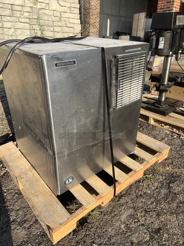 Hoshizaki 2000 lb stainless steel flake ice maker, used, no storage means, on a pallet, visible brand labels.