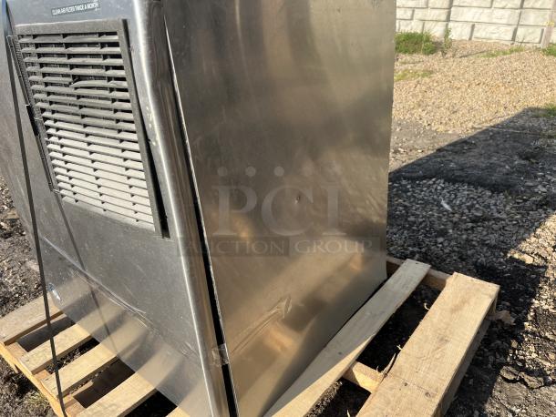 Hoshizaki 2000 lb stainless steel flake ice maker without storage. Visible air filter with cleaning label. Slight wear.