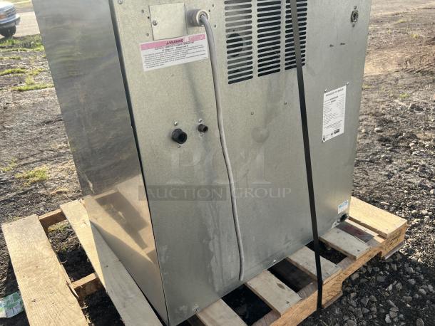 Hoshizaki 2000 lb flake ice maker, stainless steel, shown without storage, mounted on pallet. Labels and vents visible.