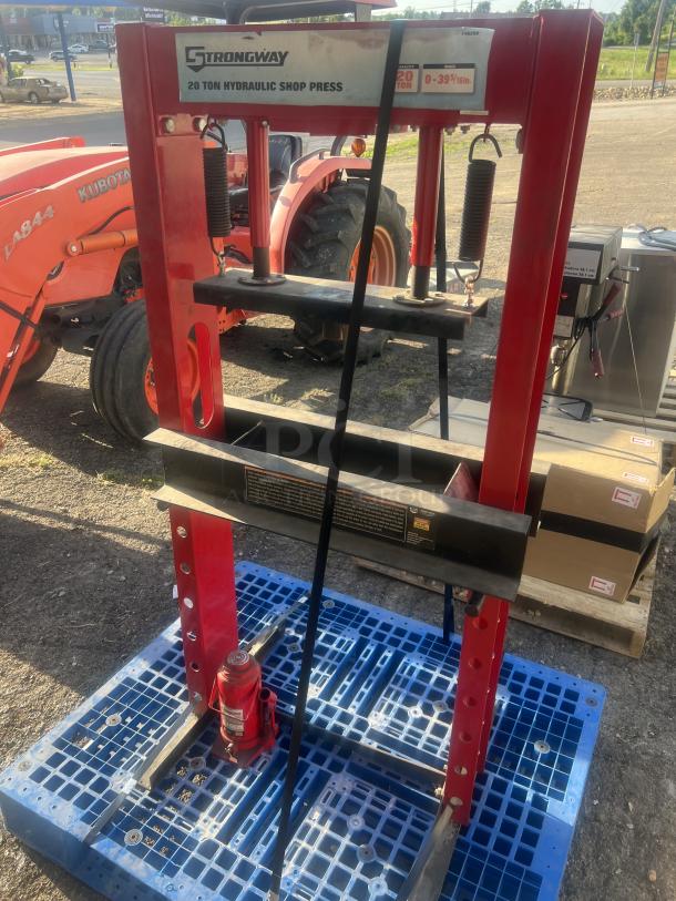 Strongway 20-ton hydraulic shop press, red, 30x24x60 inches, used condition, visible brand label, durable steel frame.