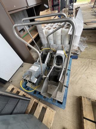 Ecolab foot sprayer on a pallet, featuring metal frame and dual brushes, in good condition. Includes attached hoses and visible labels.