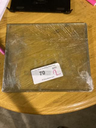 Clear glass pane, 1ft x 10.5", quantity: 2, wrapped in plastic, auction label indicating lot 70, good condition.