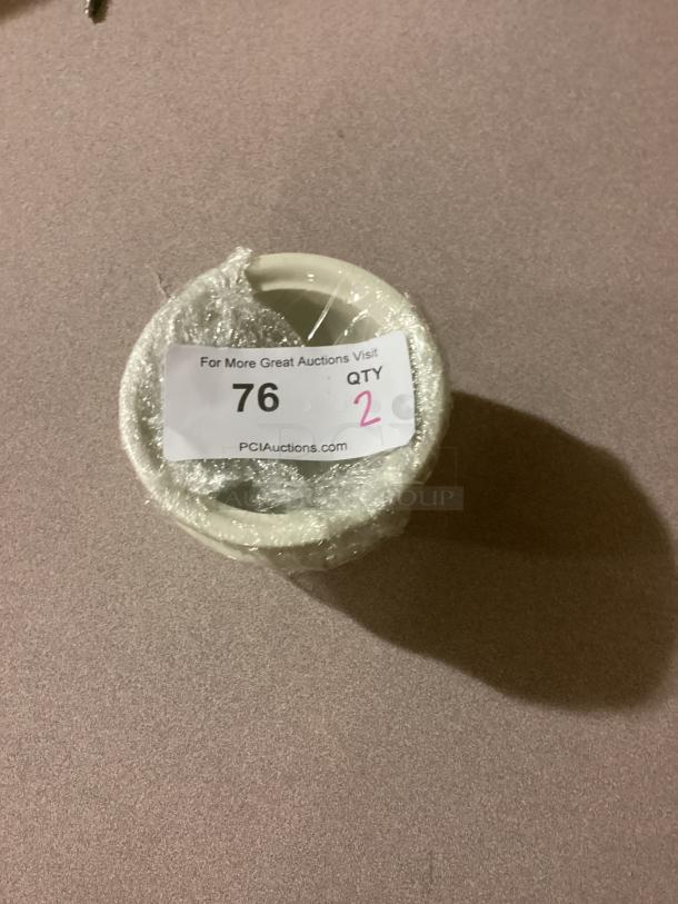 Medium gravy bowl, 5-1/8" diameter, wrapped in plastic. Auction label reads "76, QTY 2" from PCI Auctions.