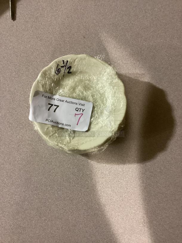 Set of 7 medium scalloped desert plates, 6-3/8 inches, wrapped in plastic. Auction lot tag indicating quantity.