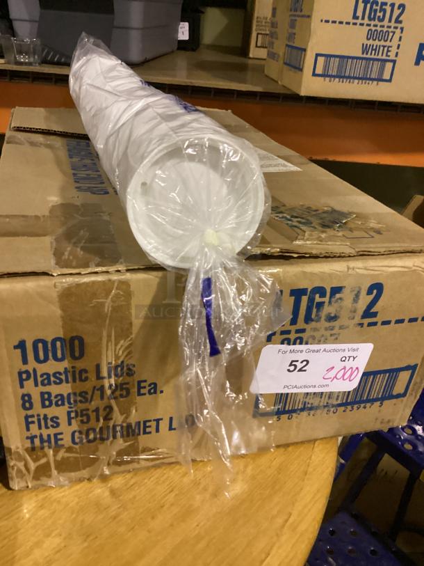 Box containing 1000 "The Gourmet Plastic Lids," labeled to fit P512. Total qty: 2,000 across boxes. Auction tag visible.