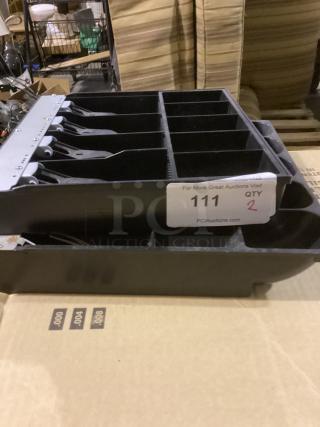 Two black cash register drawers, each with multiple compartments, in good condition. Tag reads "Qty: 2, 111."