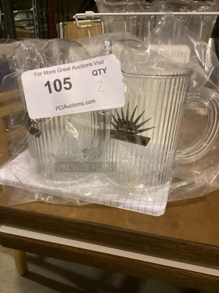 Two clear plastic beer mugs, 7-1/4 inches tall, labeled "Jose Cuervo Margarita". Packaged in plastic wrap, auction lot 105.