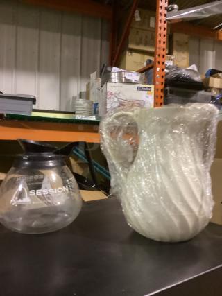 Two coffee pots; one clear glass labeled "SESSION," one ceramic wrapped in plastic, featuring a spiral design.