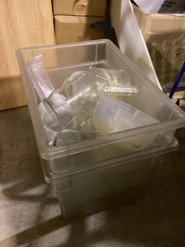 Clear plastic tub with assorted kitchenware, including pitchers and bowls. Items appear used. Quantity: 10+.