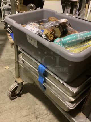 Large beer tap handles in gray bin, quantity 32. Features various styles and designs. Ideal for collectors or bars.