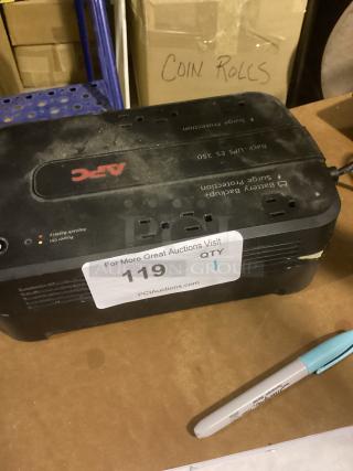 APC UPS ES 350 battery backup and surge protection unit, slightly dusty, item tag "119 QTY 1" visible on top.